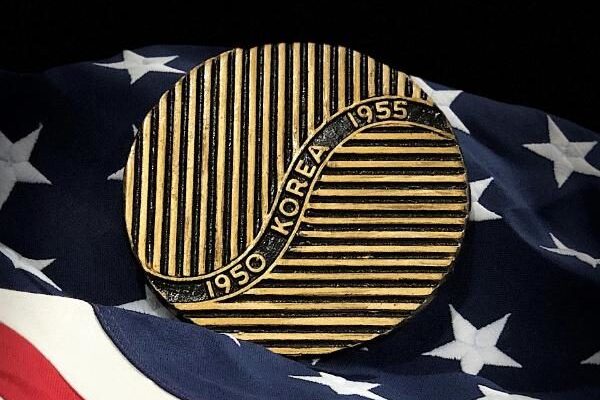 Korean War 1950-1955 U.S. Veteran marker displayed on an American flag background