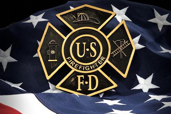 US Firefighter brass marker displayed on an American flag background