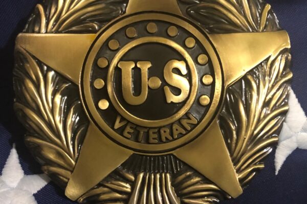 US Veteran metal marker displayed on American flag background